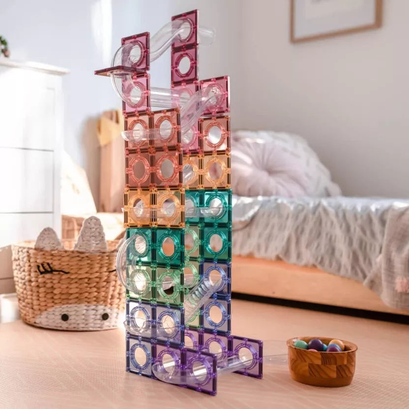 Colorful geometric tower on a wooden surface with a blurred indoor background