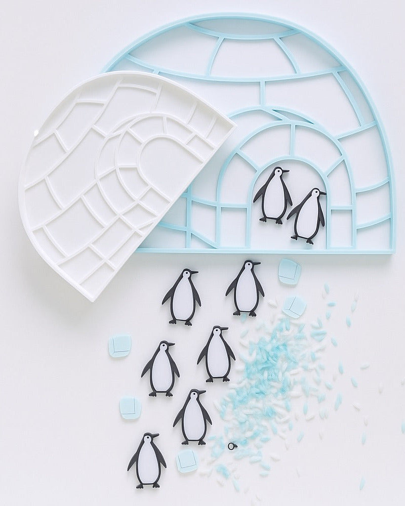 Eco-friendly 3D printed igloo sensory tray with penguins and blue rice for winter-themed sensory play, fine motor learning, and Arctic exploration.