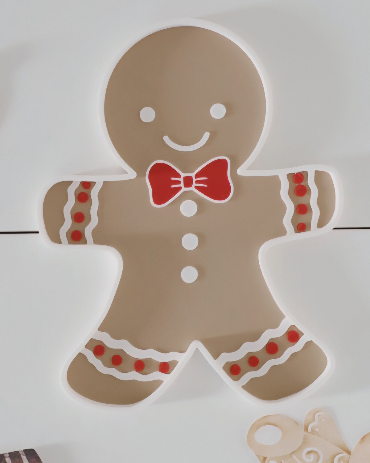 Montessori gingerbread sensory tray with red bow and festive details – designed for winter sensory play, learning and creative holiday setups