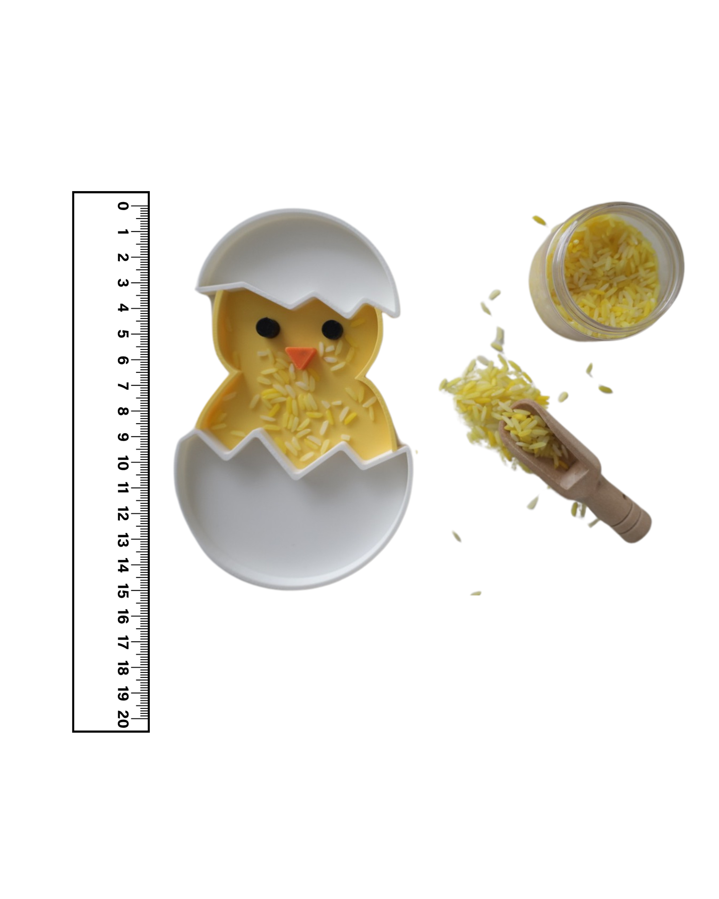 Yellow and white 3D printed chick sensory play tray by PlayTessori shown next to a ruler, approximately 14–15 cm tall, filled with colored rice and wooden scoop, eco-friendly PLA Easter sensory bin for kids