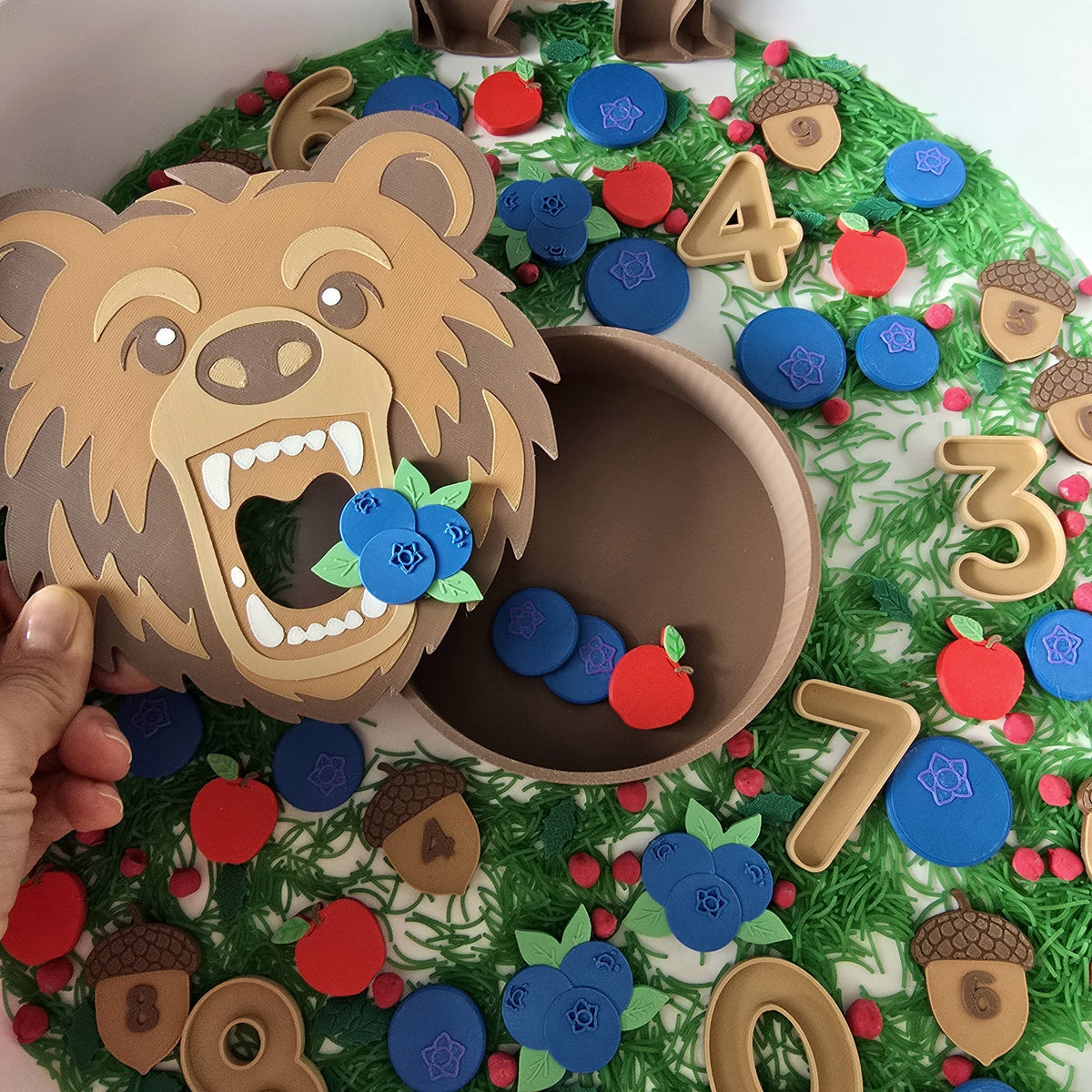 Lifting the bear head reveals the den bowl full of food