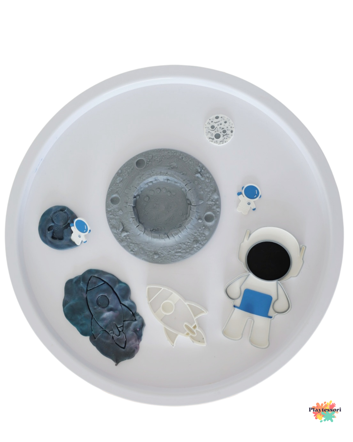 3D printed space sensory play set with moon tray, astronaut tray, rocket tray, mini moon and mini astronaut arranged inside a white sensory table.