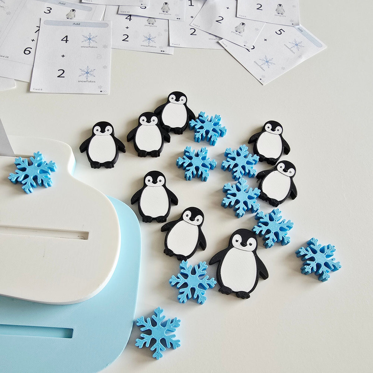 Penguins and snowflakes next to the ice floe tray