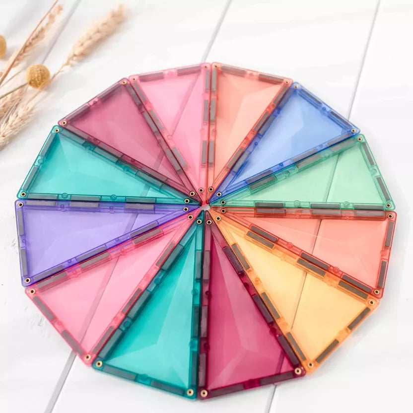 Colorful geometric building blocks arranged in a circular pattern on a white surface.