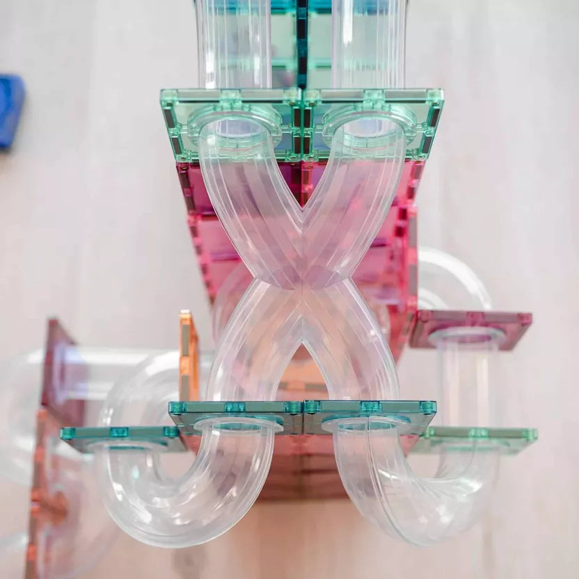 Colorful plastic letter 'X' sculpture on a white background