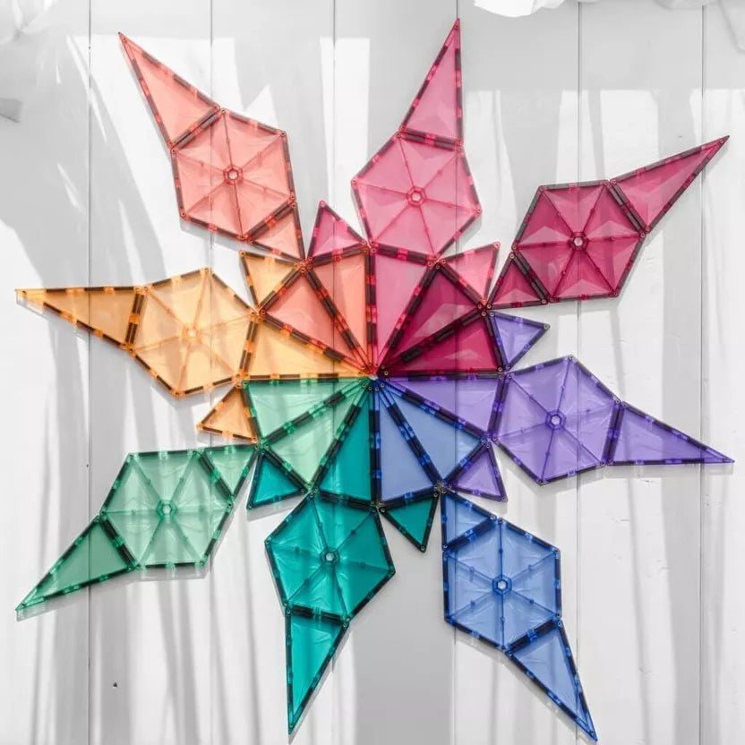 Colorful geometric wall art on a white wooden background