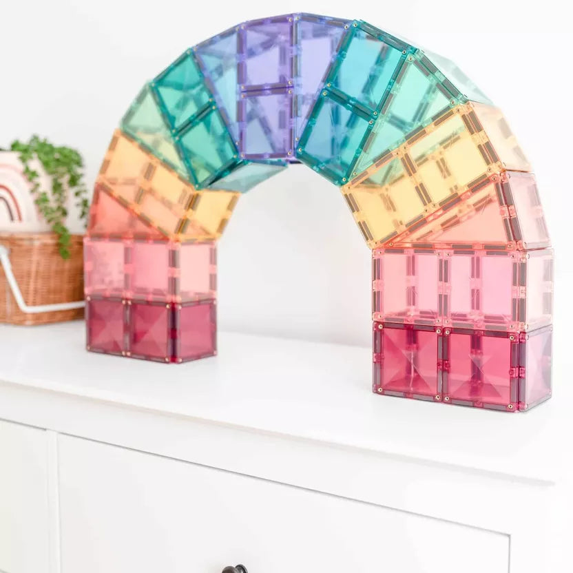 Colorful transparent arch made of interlocking bricks on a white surface.