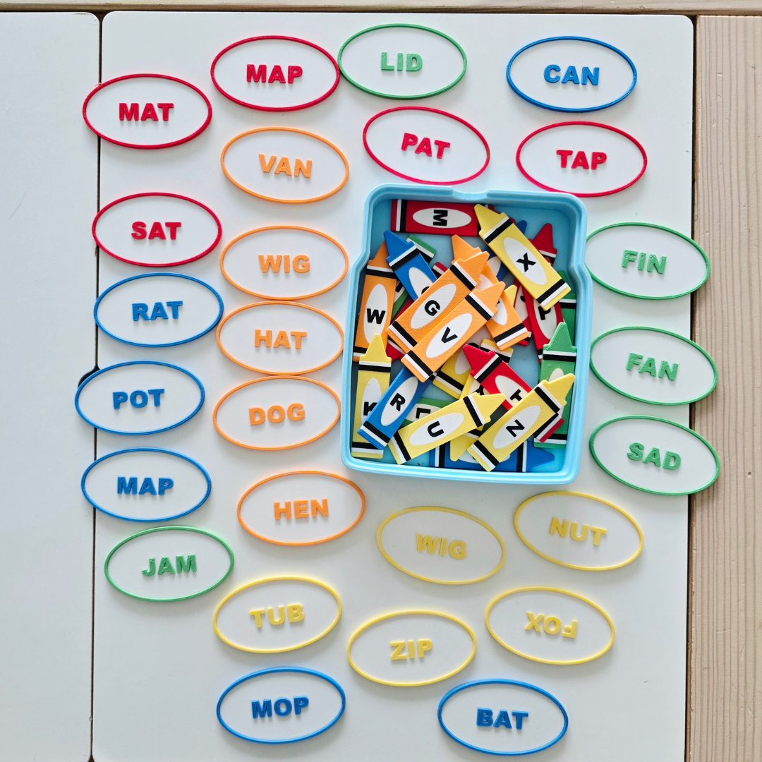 Full CVC crayons box set with color-coded word ovals and letter crayon tiles for phonics practice