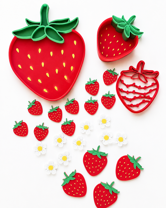 Strawberry-shaped cutters and sensory tray with cutters on a white background