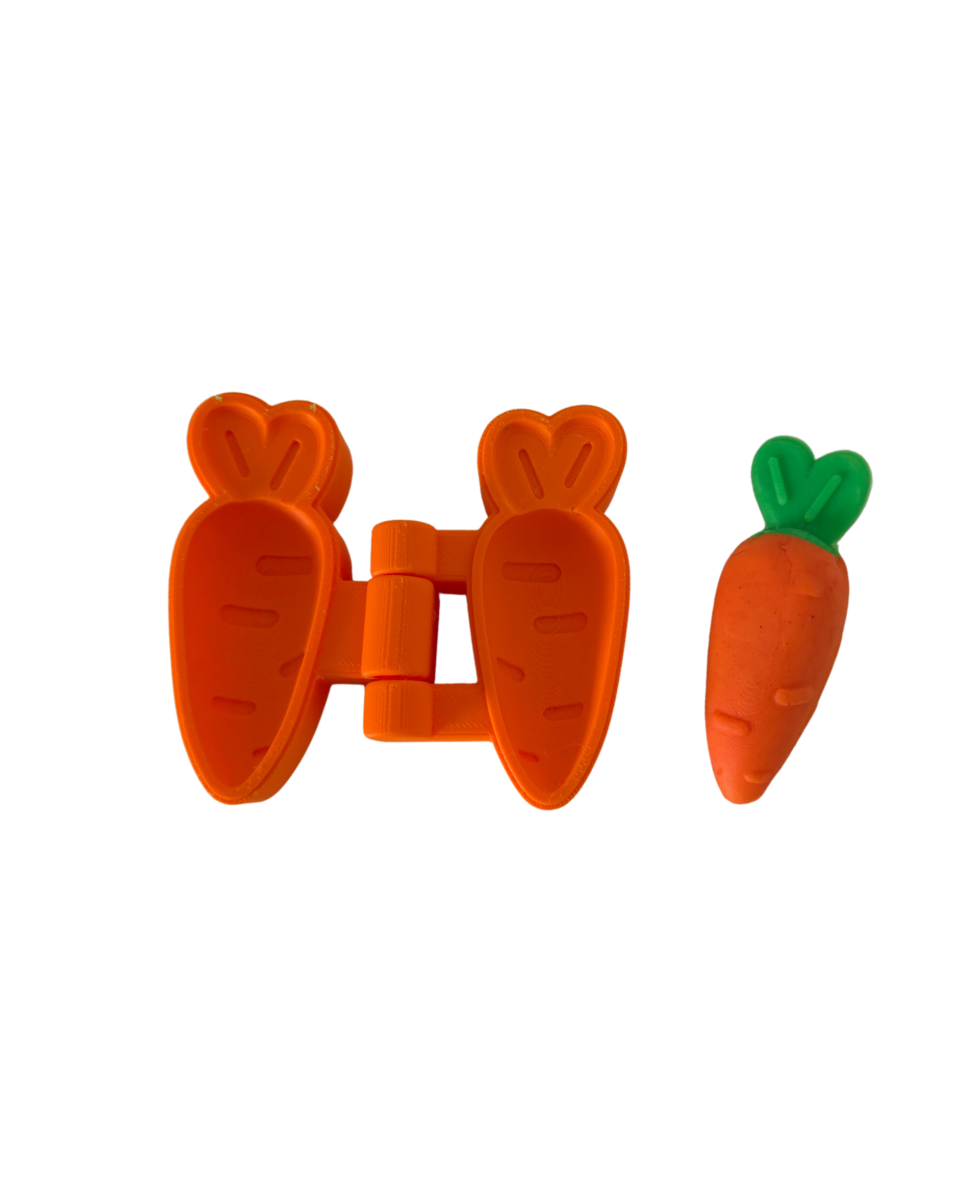 Orange 3D printed two-part hinged carrot playdough mold by PlayTessori, shown open and closed next to a finished orange and green playdough carrot, Montessori Easter spring sensory tool