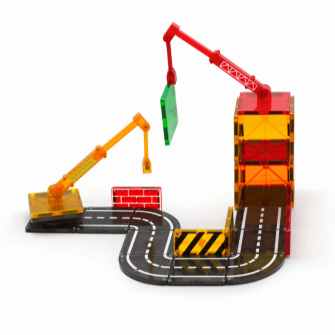 Toy construction set with cranes and road tracks on a white background