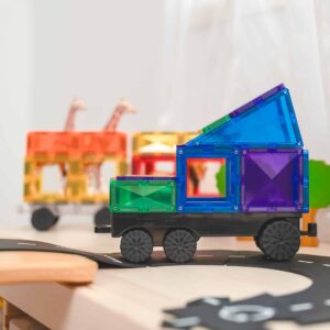 Colorful toy truck made of interlocking bricks on a wooden surface with blurred background