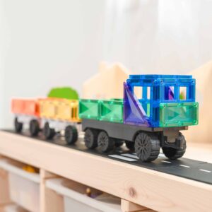 Colorful toy truck on a wooden track with a white background