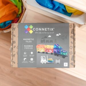 Connetix magnetic tiles packaging on a wooden surface with colorful tiles in the background