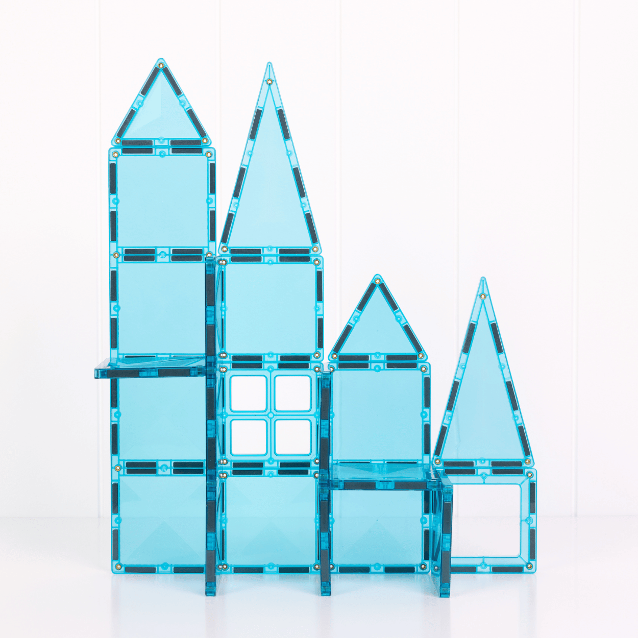 Blue transparent magnetic building blocks on a white background