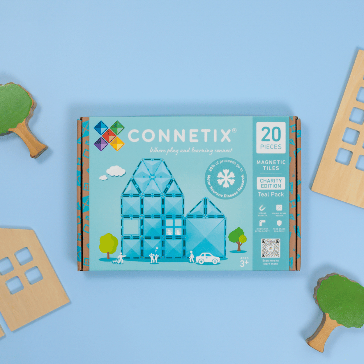 Connetix magnetic tiles packaging on a blue background with toy pieces around